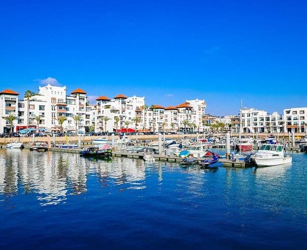 Agadir marina with boats and modern buildings along the Atlantic coast of Morocco, a popular seaside travel destination