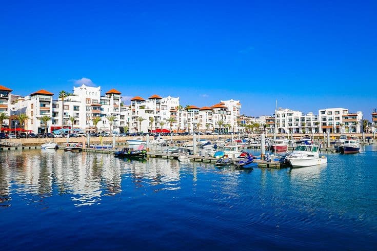 Agadir marina with boats and modern buildings along the Atlantic coast of Morocco, a popular seaside travel destination