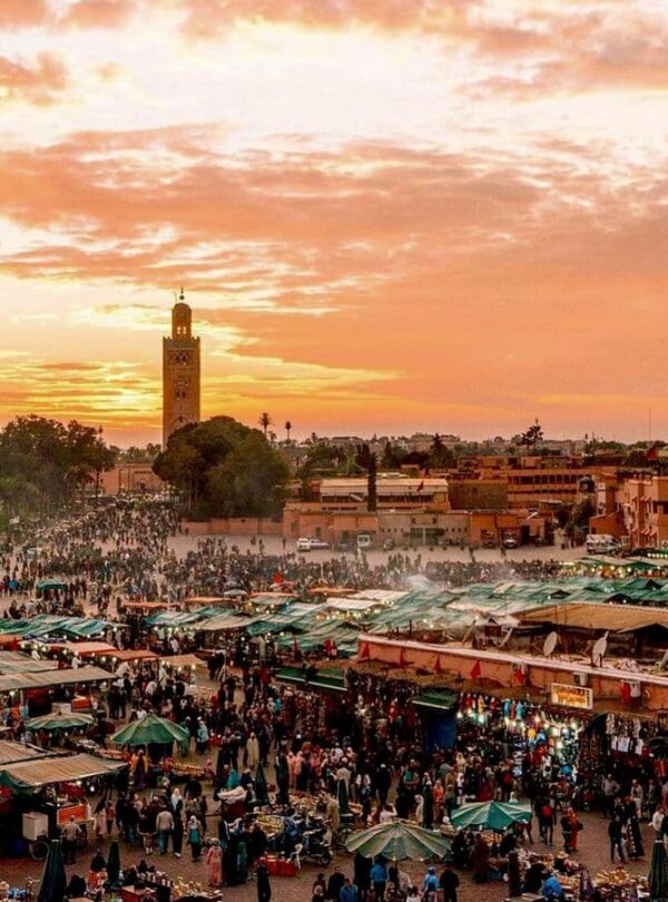 Jemaa el-Fnaa square in Marrakech at sunset with lively market atmosphere, a must-see stop on Morocco cultural and city tours