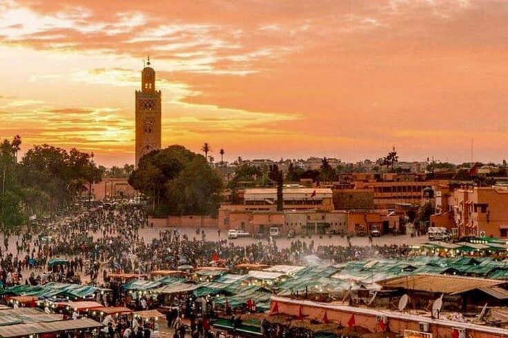 Jemaa el-Fnaa square in Marrakech at sunset with lively market atmosphere, a must-see stop on Morocco cultural and city tours
