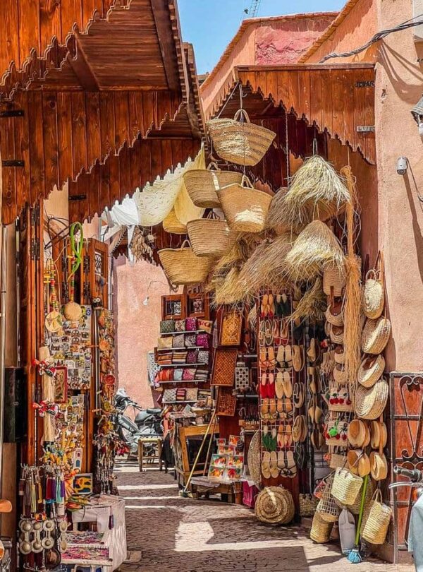 Traditional souk in the Marrakech medina with handmade baskets, leather goods, and Moroccan handicrafts in a narrow alley