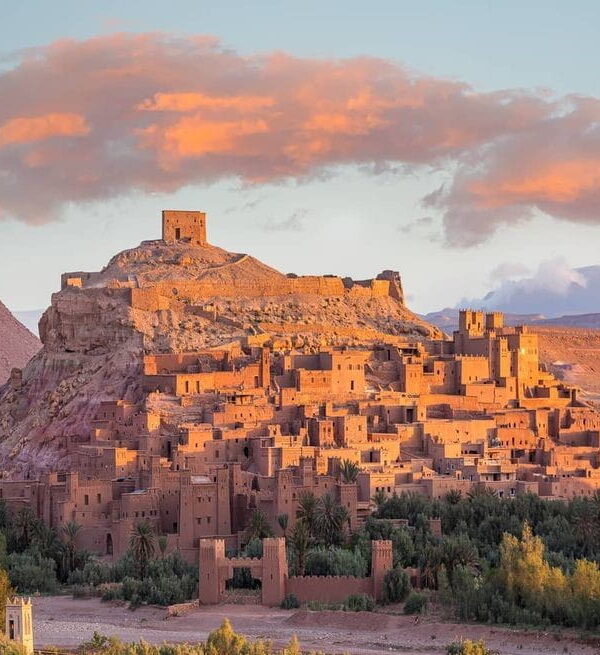 Ait Ben Haddou fortified kasbah at sunset in southern Morocco, popular day trip from Marrakech across the Atlas Mountains.