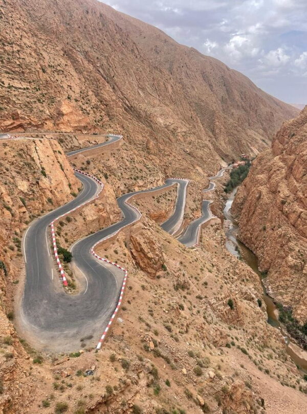 Famous winding road through Dadès Valley surrounded by rocky Atlas landscapes, part of southern Morocco adventure routes.