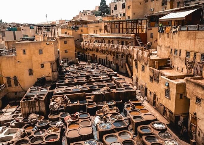 Chouara tannery in Fes Medina with traditional leather dye pits and artisans working in Morocco
