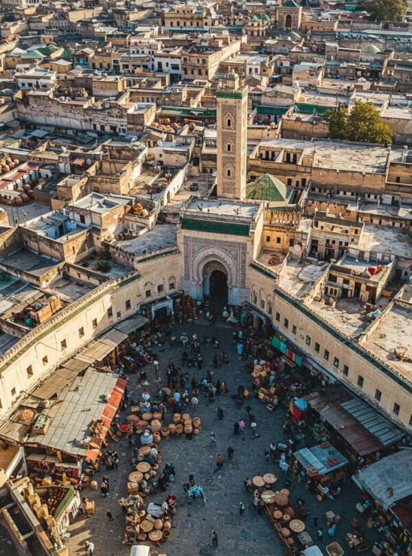 Aerial view of Fes old medina with traditional architecture and historic mosques during a guided Morocco journey.