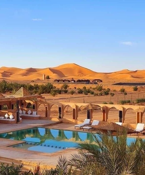 Luxury desert hotel with swimming pool overlooking Erg Chebbi dunes in Merzouga Morocco