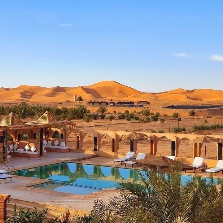 Luxury desert hotel with swimming pool overlooking Erg Chebbi dunes in Merzouga Morocco