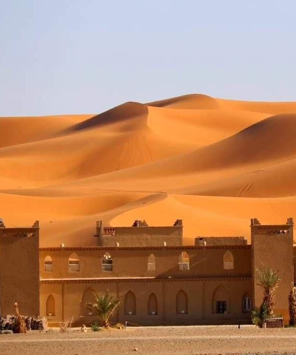 Desert camp at the foot of golden Erg Chebbi dunes in Merzouga Sahara Morocco