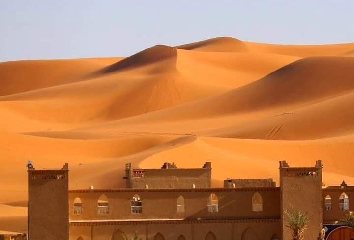 Desert camp at the foot of golden Erg Chebbi dunes in Merzouga Sahara Morocco