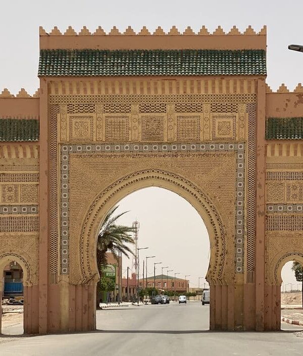 Traditional decorative arch gate entrance to Rissani town in Tafilalet region Morocco