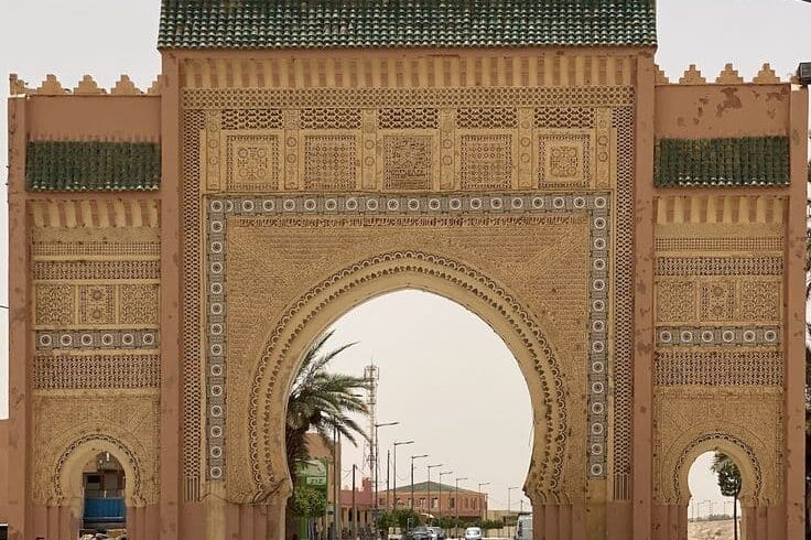 Traditional decorative arch gate entrance to Rissani town in Tafilalet region Morocco