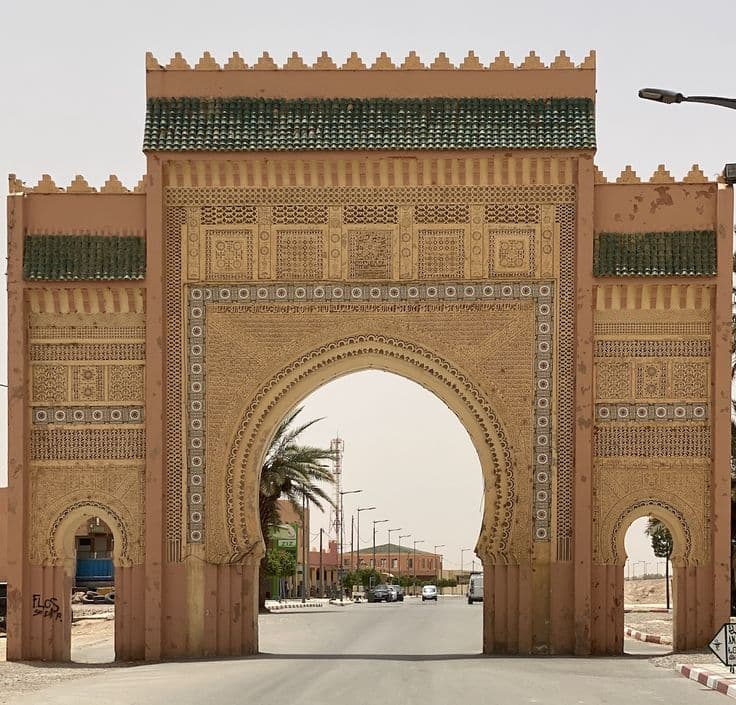Traditional decorative arch gate entrance to Rissani town in Tafilalet region Morocco
