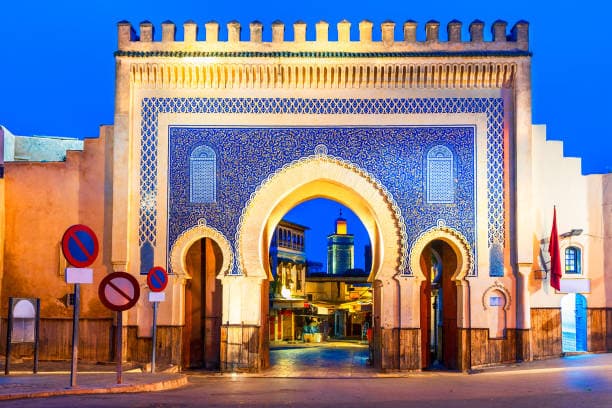 Bab Boujloud Blue Gate entrance to Fes Medina at dusk Morocco
