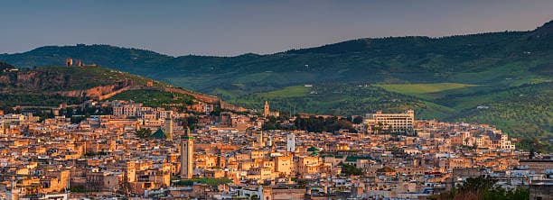 Panoramic view of Fes city and old medina surrounded by green hills Morocco